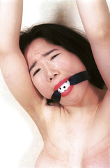 Naked asian strapped with arms overhead