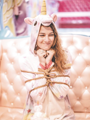 Two girls tied in their fleece unicorn onesies