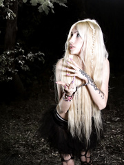 Blonde in the forest in handcuffs