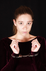 The girl in the purple dress is handcuffed