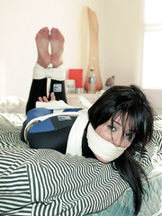 Woman hogtied in wetsuit