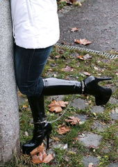 Hancuffed and shackled in puffer jacket and boots